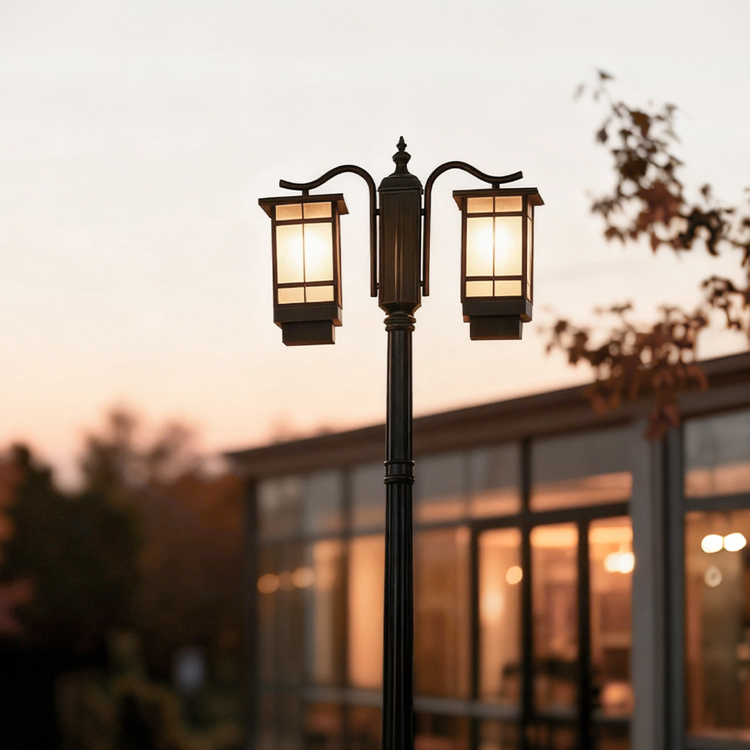 2 head outdoor post light illuminating garden pathway with warm glow at dusk.
