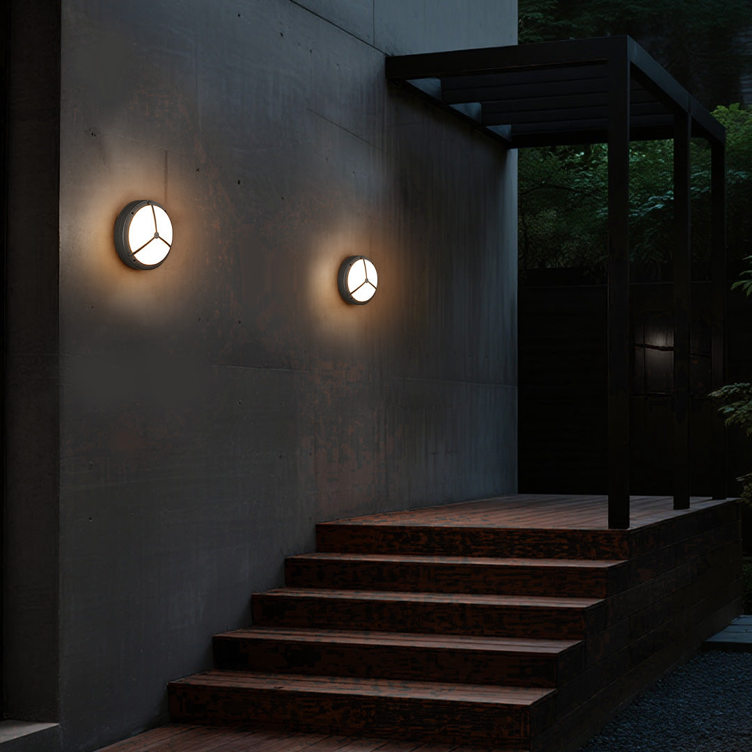 Two waterproof outdoor wall lightings brightening dark grey exterior stairway at night
