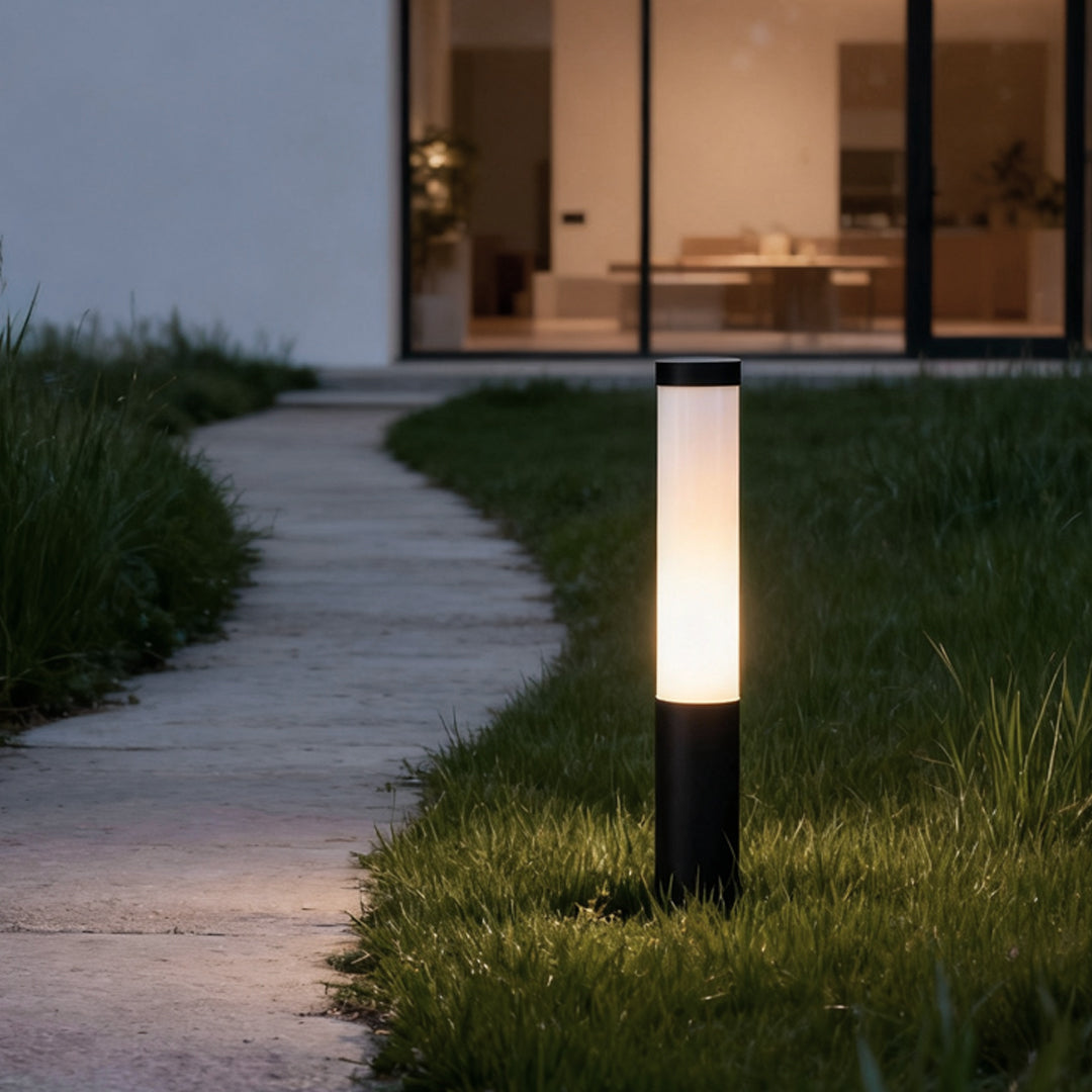 Ube landscape light casting a soft glow on a curved garden path, surrounded by greenery.