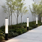 Ube landscape light illuminating a garden pathway, providing modern and minimalist outdoor lighting.
