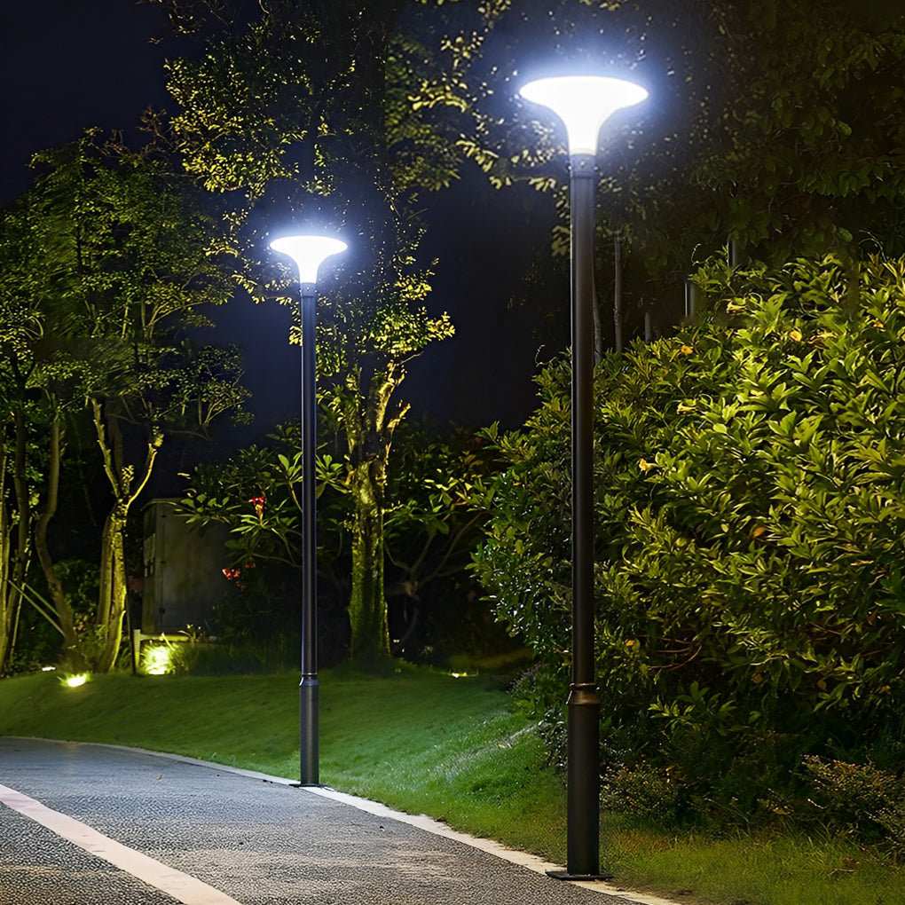 UFO solar street lights lighting a park pathway at night.