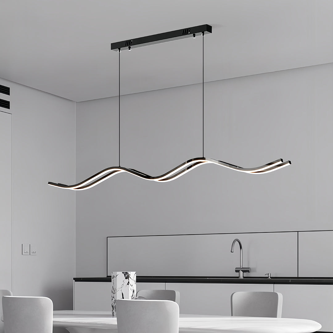 Ultra-minimalist black kitchen island pendant light featuring a continuous, undulating dark frame over a white dining area.