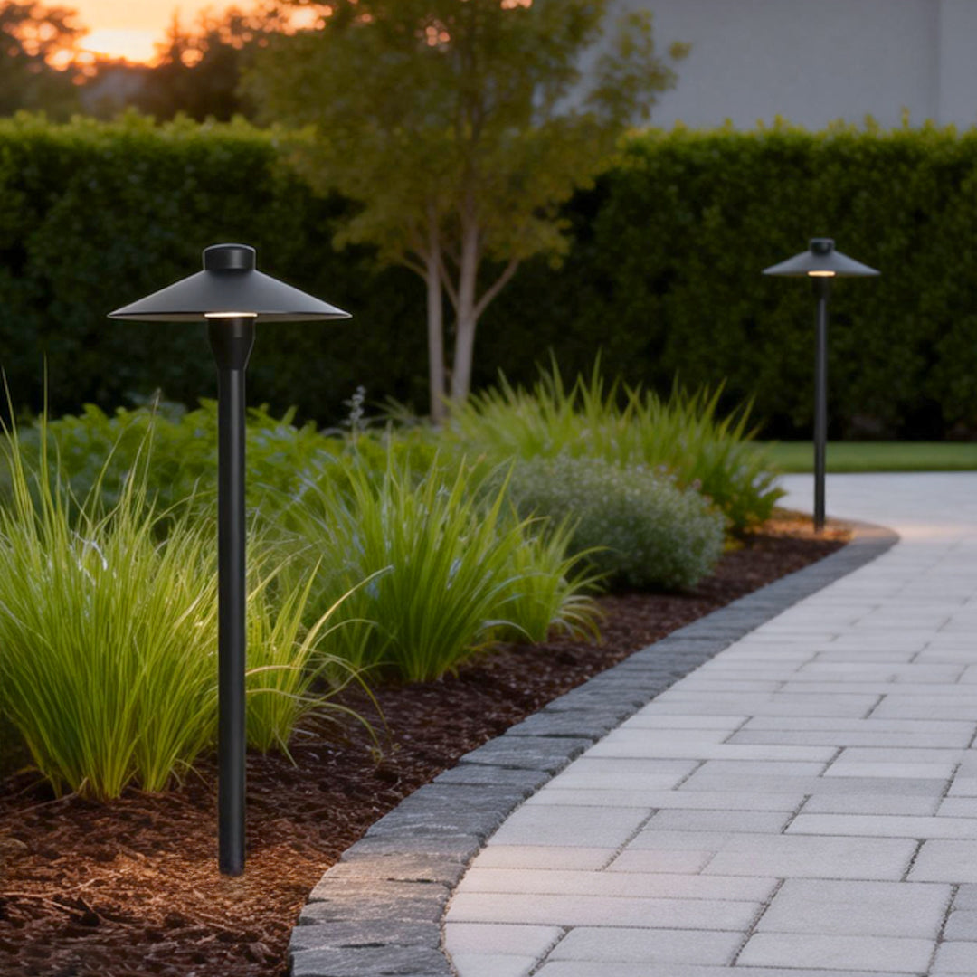 Umbrella path lamp illuminating a modern garden walkway with warm directional glow.