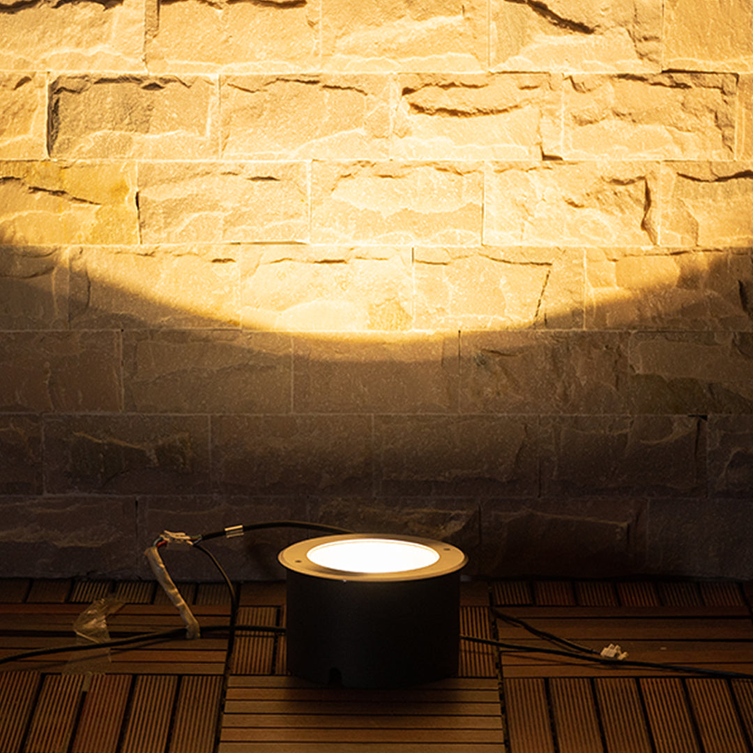 Underground lighting fixture casting beautiful upward glow on textured stone ceiling surface