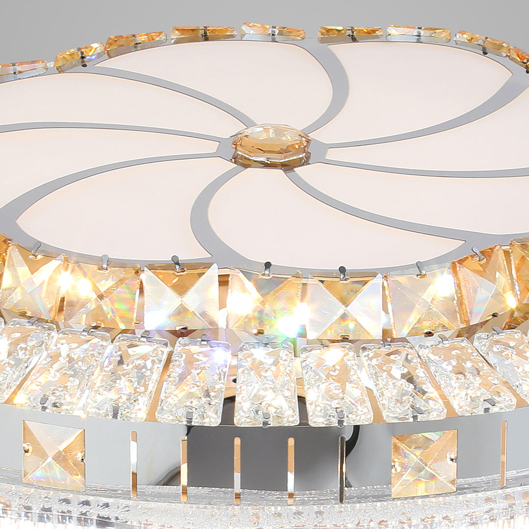 Underside view of retractable gold ceiling fan with light featuring a decorative center pattern 