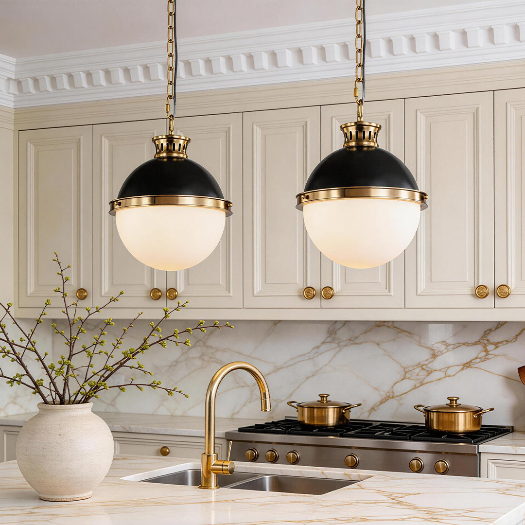 Unique ball pendant light with black and gold metal dome and frosted white glass globe.