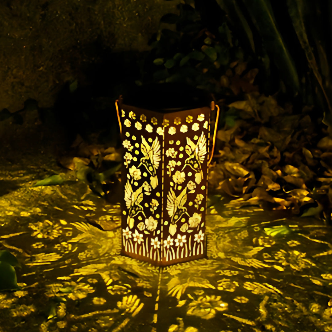 Unique cutout design red outdoor lantern providing ambient glow for landscaping and outdoor seating areas.