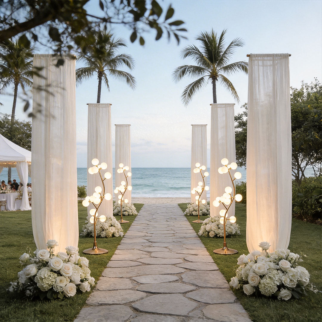 Unique decorate floor lamp used for beach wedding aisle decor with white fabric and flowers.