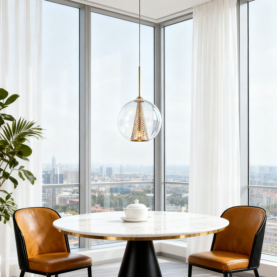 Unique glass ball pendant lights with an internal Eiffel Tower motif and a rose gold finish, hanging over a modern dining table.