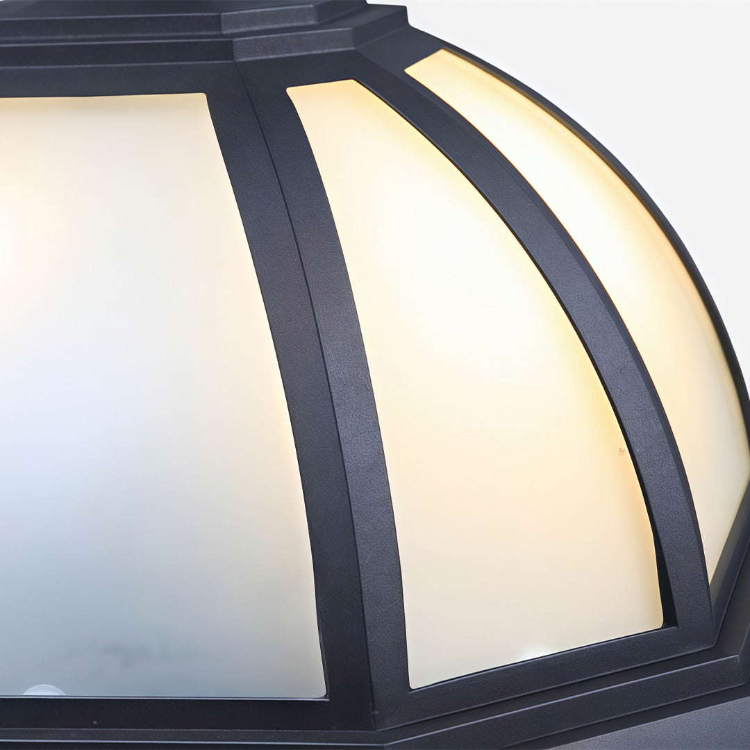 Close-up of unique flush mount lighting with a textured black frame and frosted glass panels.