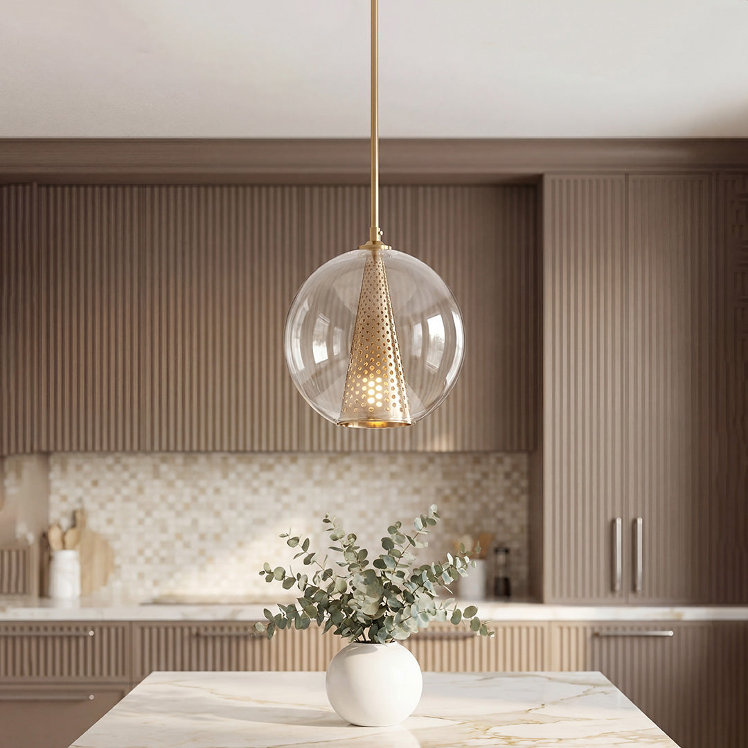 Unique glass ball pendant lights with a gold perforated cone core in a warm modern kitchen.