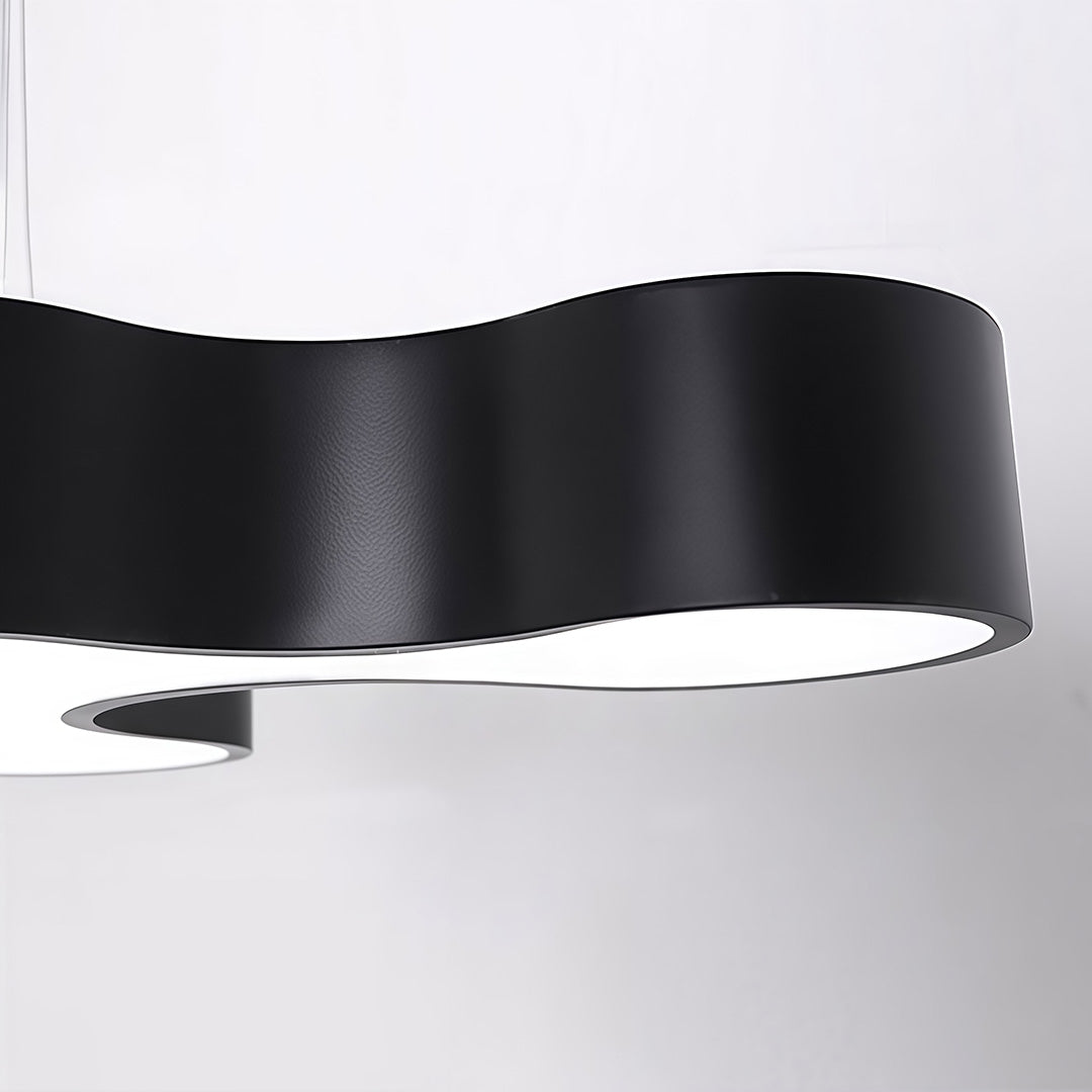 Unique modern chandelier with a close-up of the curved black and white design.