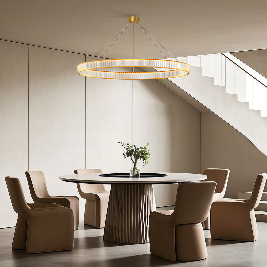Unique modern chandeliers above contemporary dining space with brown upholstered chairs
