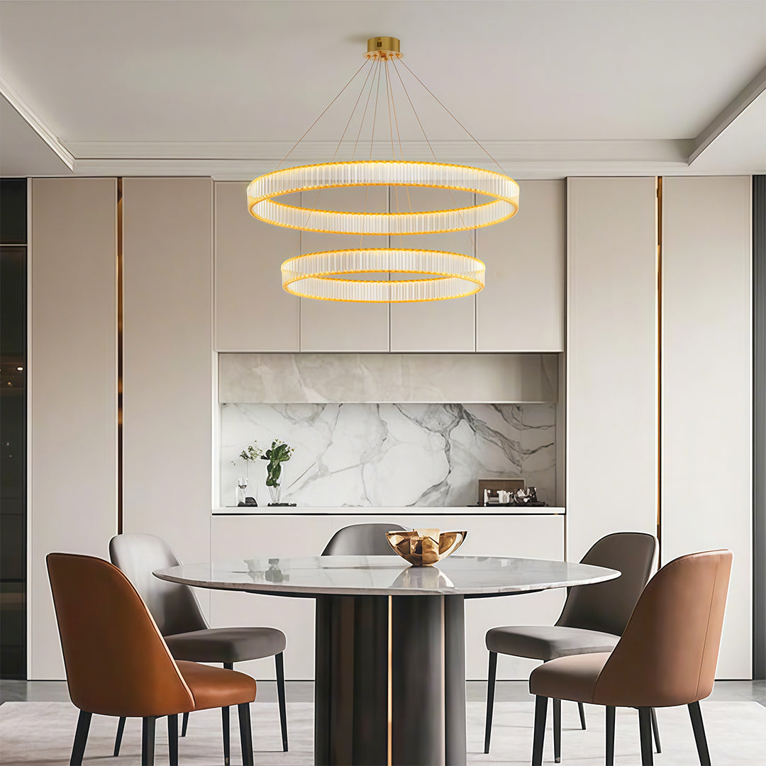 Unique modern chandeliers illuminating cozy dining space with rust-colored chairs