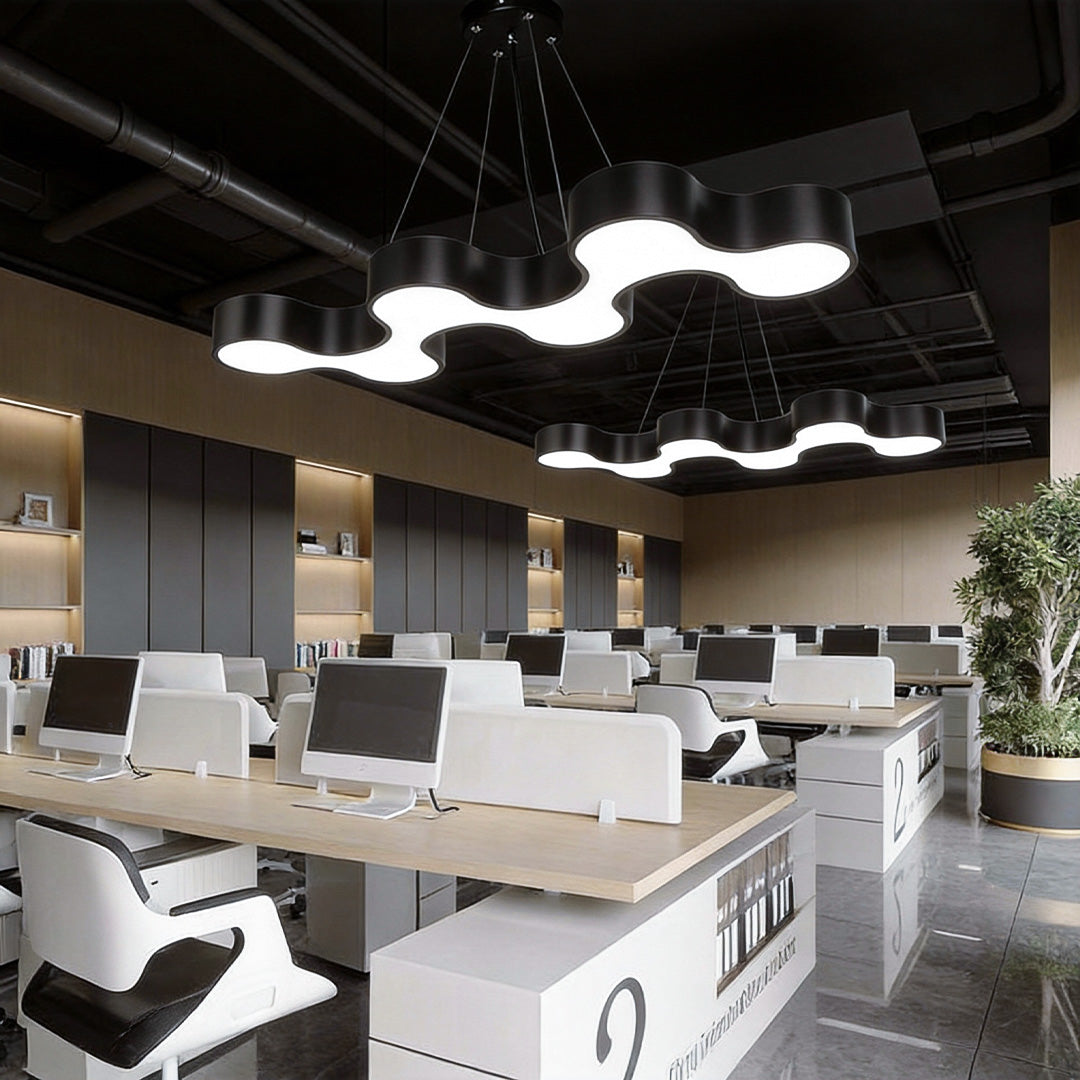 Unique modern chandelier enhancing a creative office area with wave-inspired design.