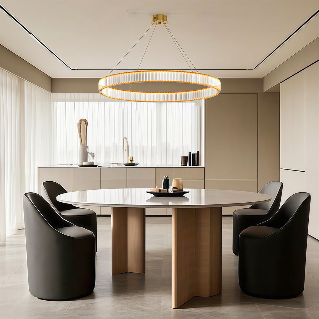 Modern luxury chandeliers above elegant dining table with curved chairs and neutral palette