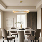 Modern luxury chandeliers illuminating elegant dining room with round table and velvet chairs