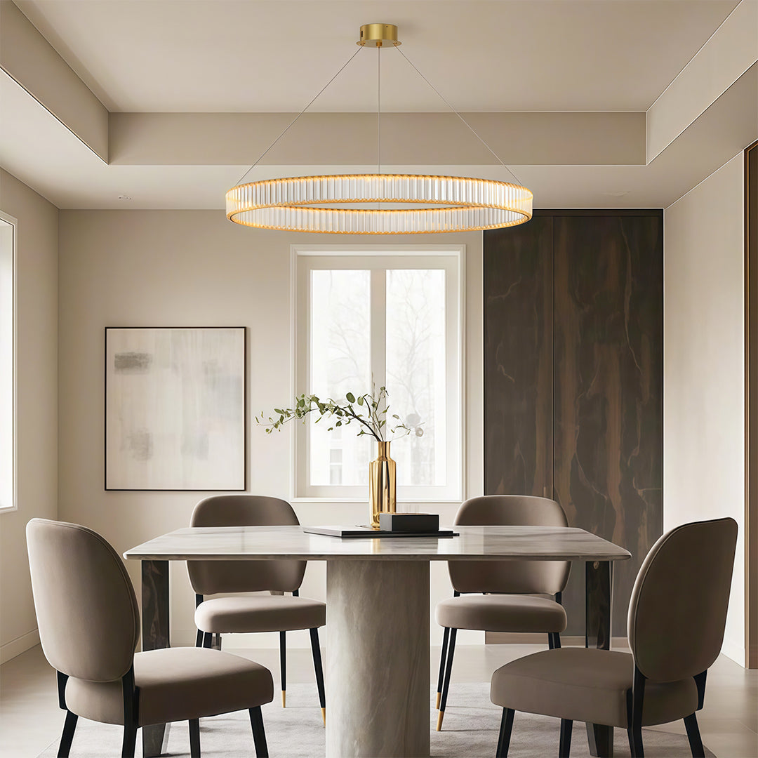 Modern luxury chandeliers illuminating elegant dining room with round table and velvet chairs