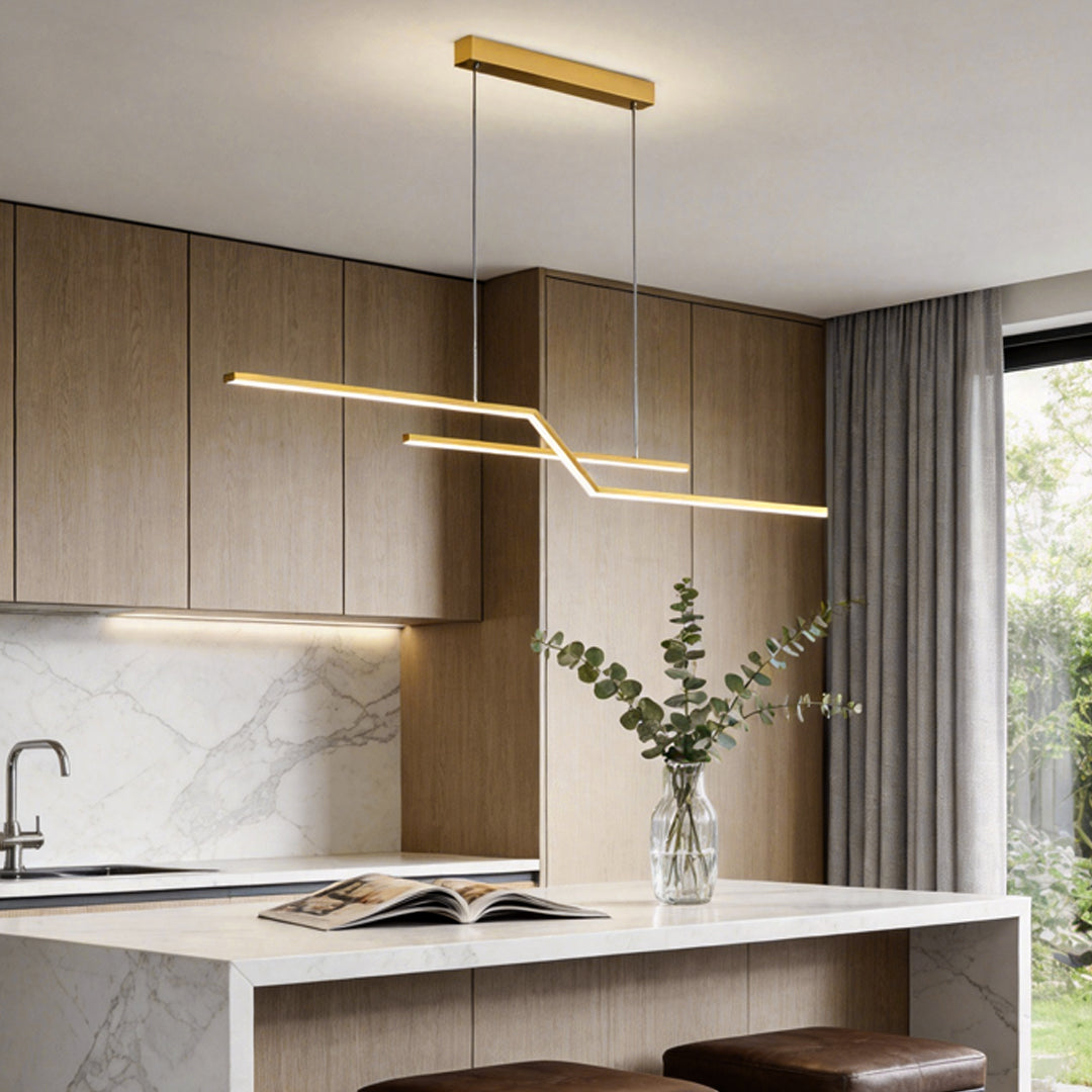 Unique pendant lighting with a modern linear gold design suspended above a kitchen island, adding warmth and architectural style.