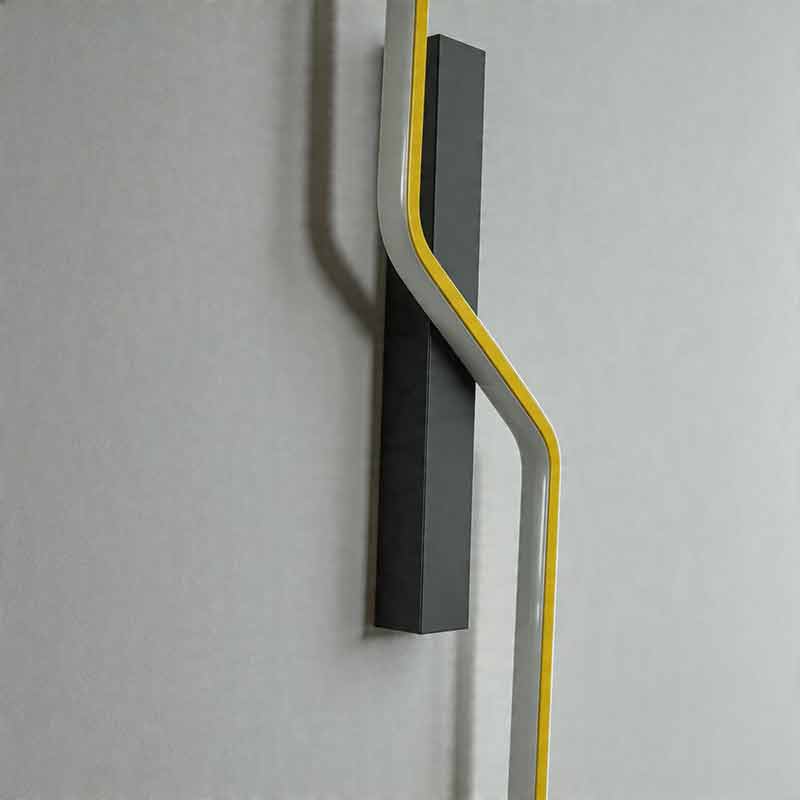 Close up detail of unlit modern linear wall sconce showing its black base and curved design ok