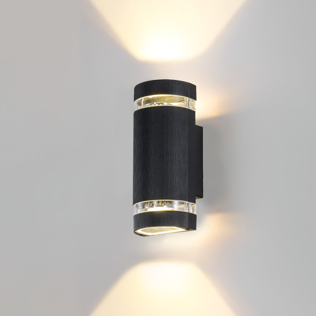 Close-up of up and down light wall sconce showing black finish and clear light rings.