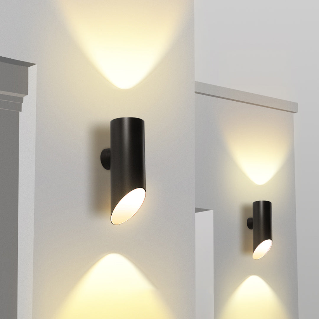 Contemporary hallway illuminated by multiple black up and down wall lights creating vertical light beams.