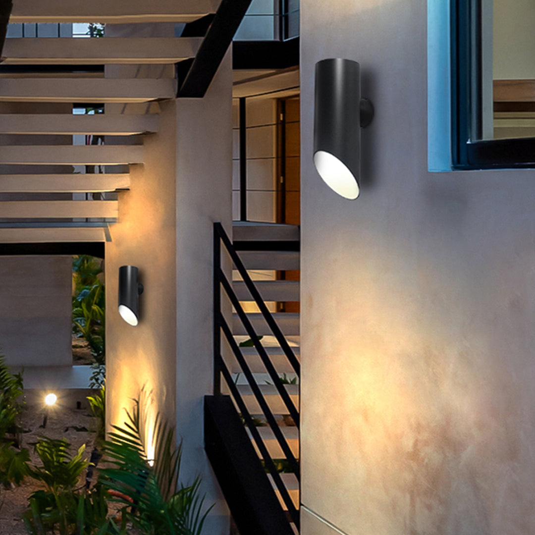 Outdoor patio area enhanced with modern up and down wall lights providing warm architectural illumination.