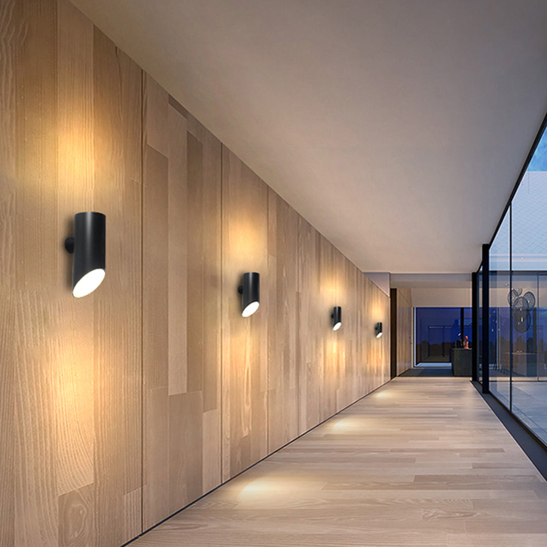 Long exterior corridor lit evenly with minimalist up and down wall lights for clean architectural lighting.