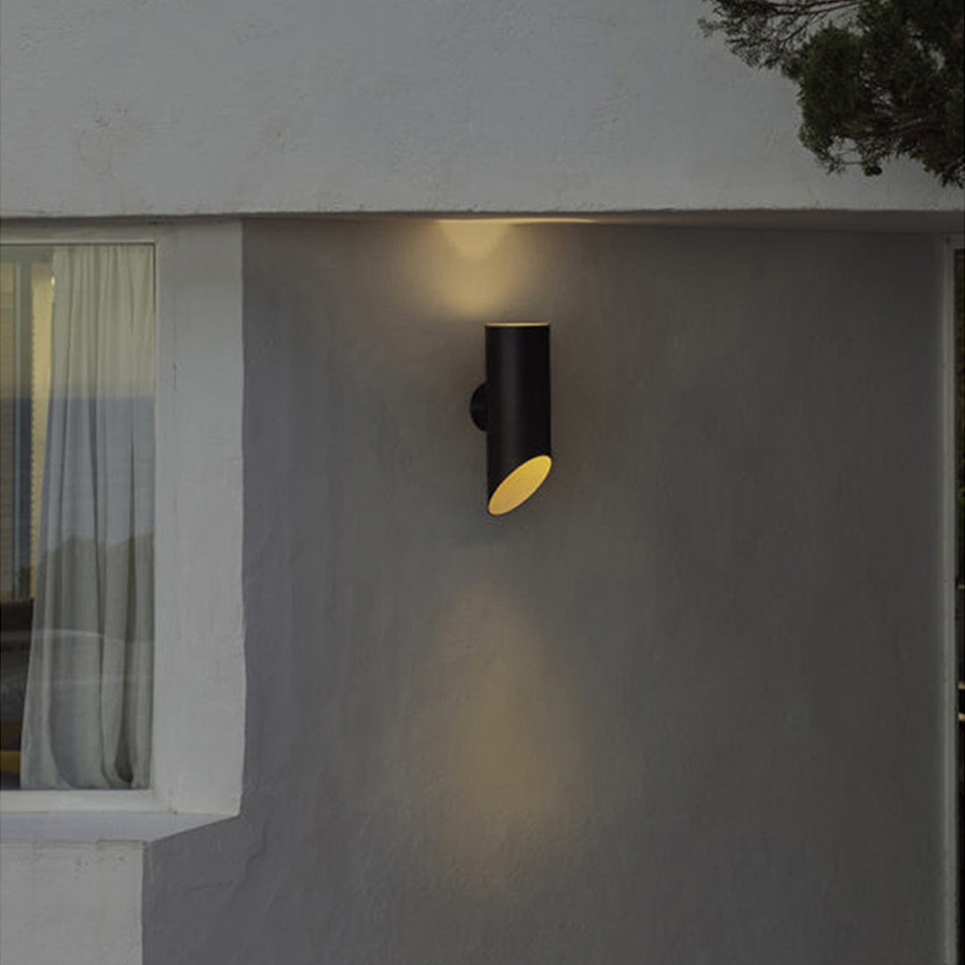 Modern façade featuring dark-finished up and down wall lights casting warm dual-direction beams.