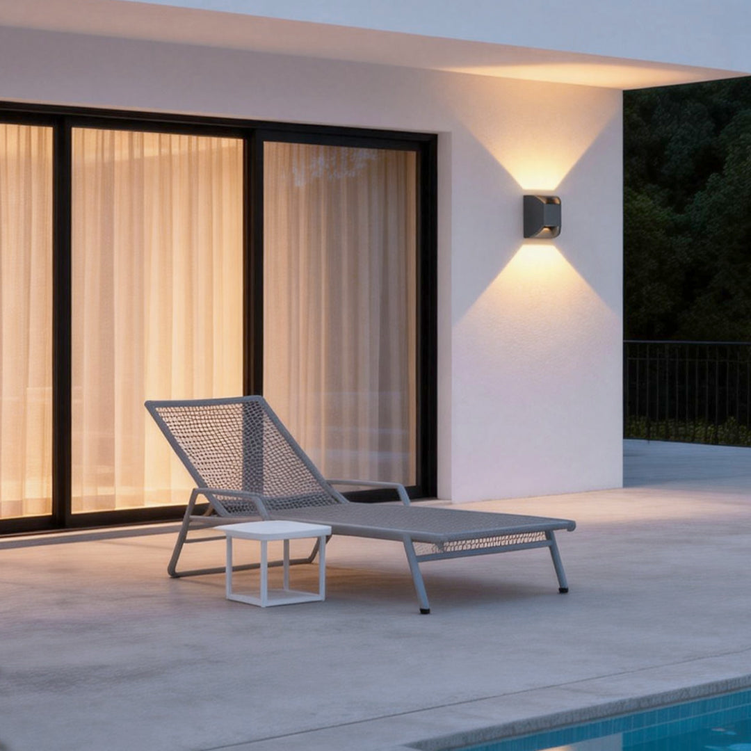 Up and down exterior lights illuminating a modern patio with warm directional glow.