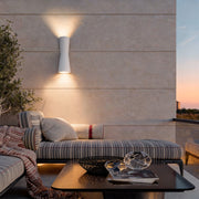 Up and down exterior wall light illuminating an outdoor patio wall with warm ambient lighting.