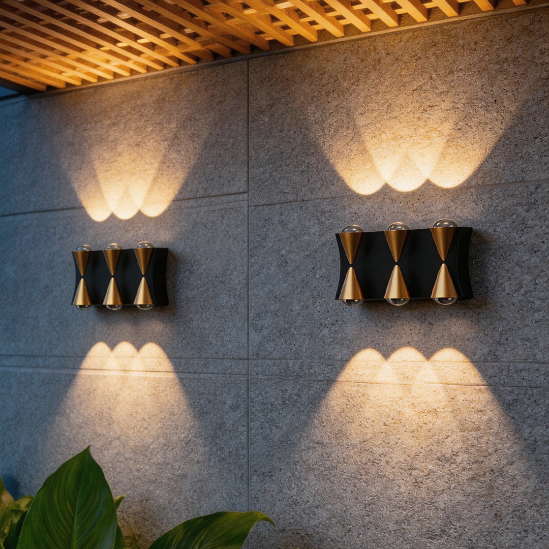 Up down lighting wall lights with a modern gold and black design, providing warm illumination.