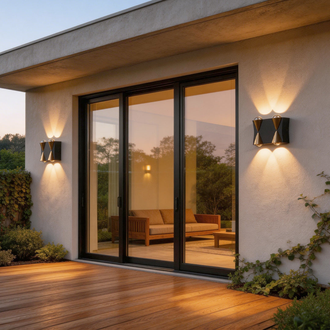 Up down lighting wall lights with a sleek gold design, enhancing a modern house exterior.