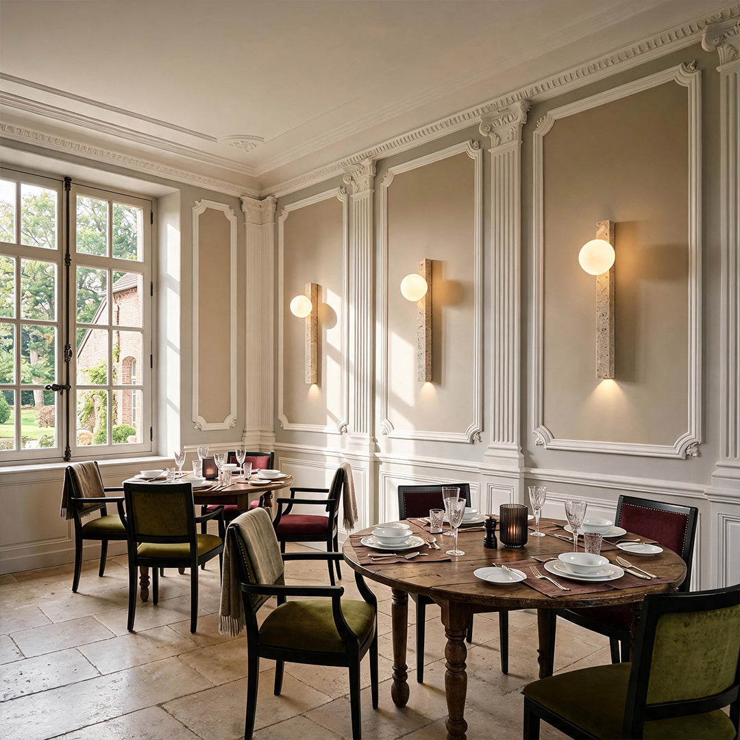 Up down lighting wall sconce creating elegant ambient light in a refined dining room.