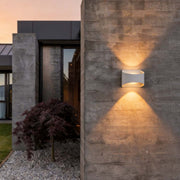 Up and down wall sconce lighting installed on an exterior brick wall, providing modern illumination.