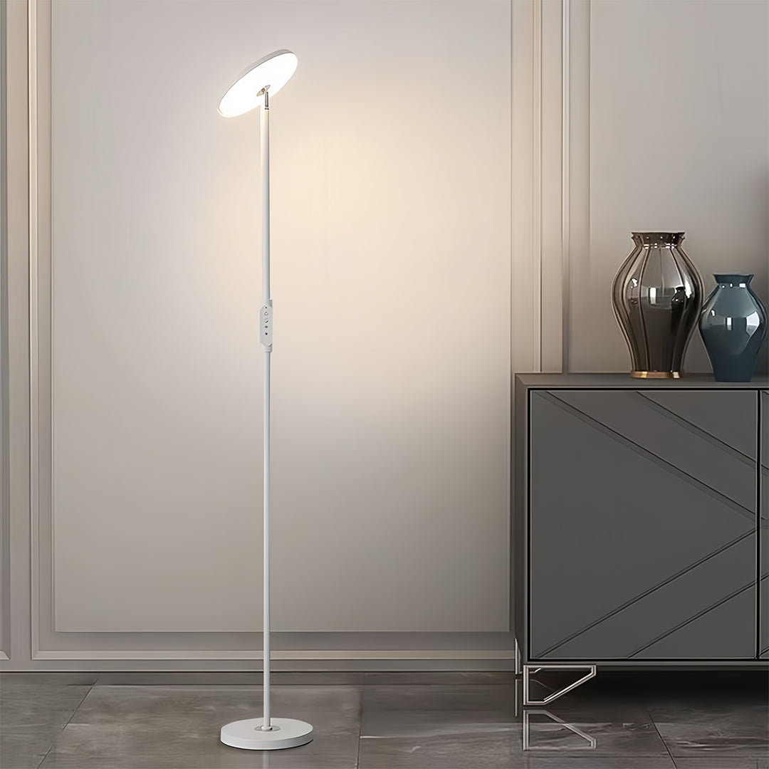 Uplight floor lamp beside comfortable seating creating cozy atmosphere with warm upward lighting