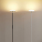 Uplight floor lamp in modern living space with geometric furniture and sophisticated lighting design