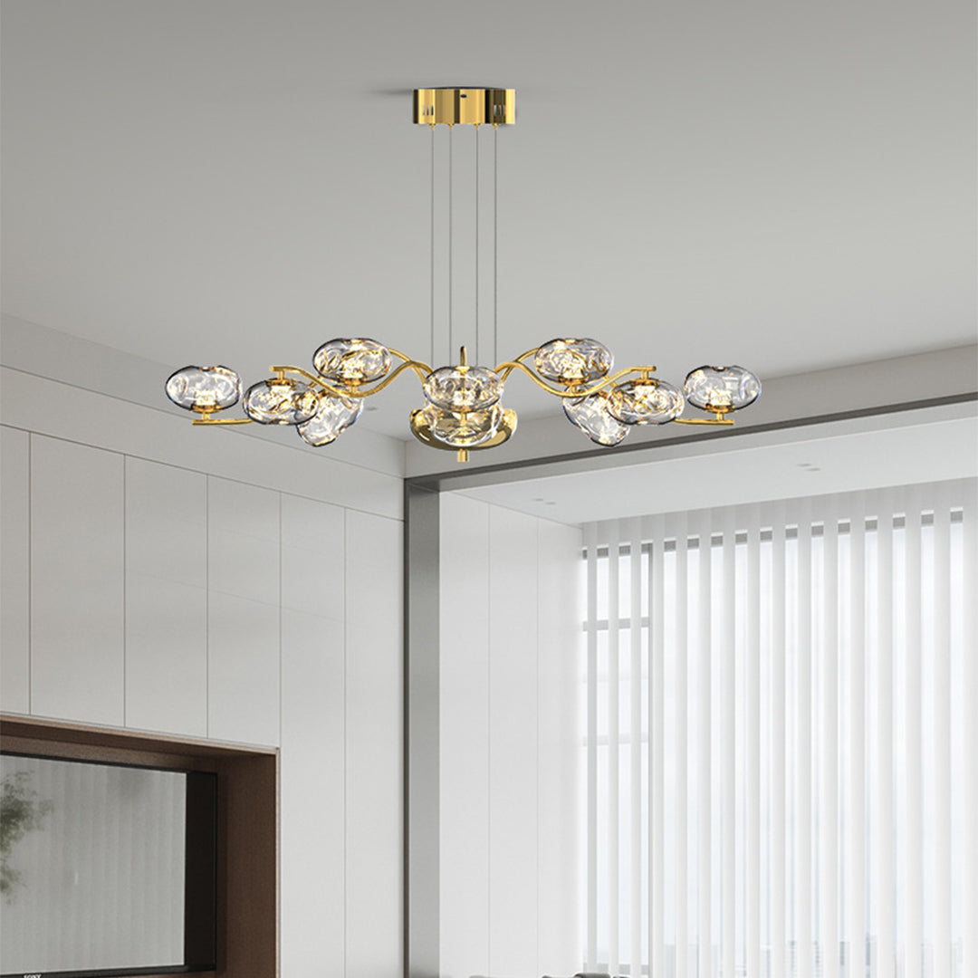 Modern LED chandelier installed in upscale kitchen area featuring gold accents and decorative glass shades