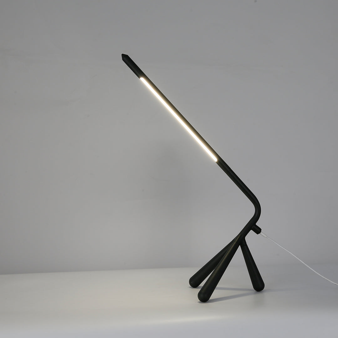 Versatile three legged table lamp in black providing ambient lighting for modern living spaces