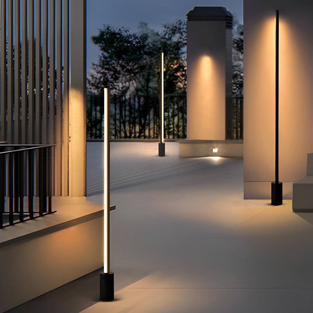 Minimalist vertical contemporary outdoor floor lamps illuminating a modern architectural entrance path.