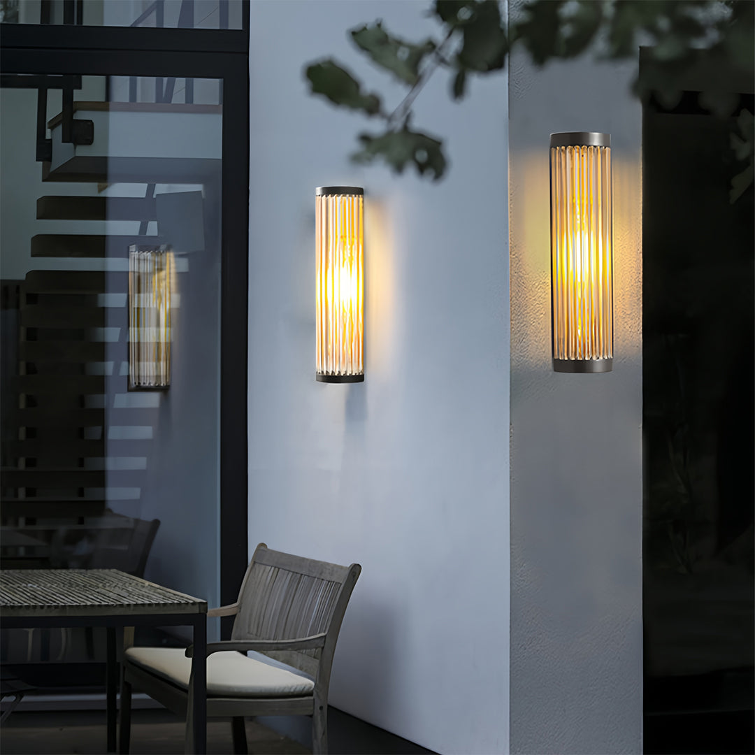 Outdoor wall LED light illuminating a small patio dining area, featuring a long, vertical design for ambient light.