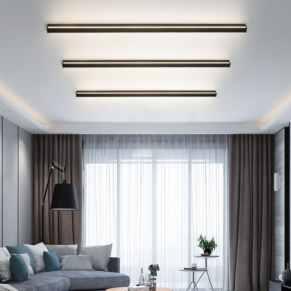 Vertical linear outdoor wall sconce with warm LED light, installed beside a bookshelf for modern interior-exterior harmony.