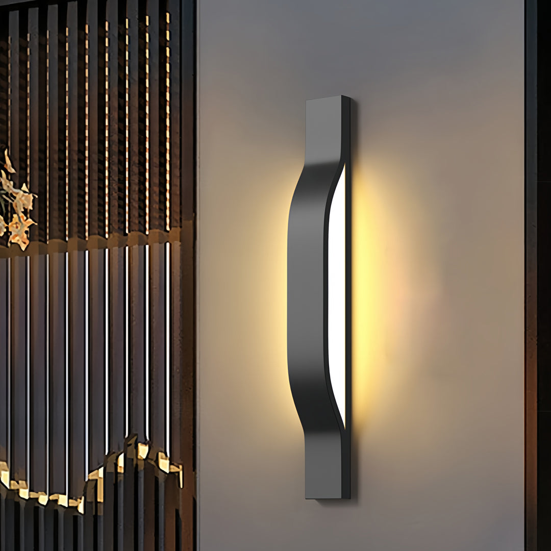 Sleek vertical outdoor exterior wall lights installed beside decorative metal panels with warm glow.