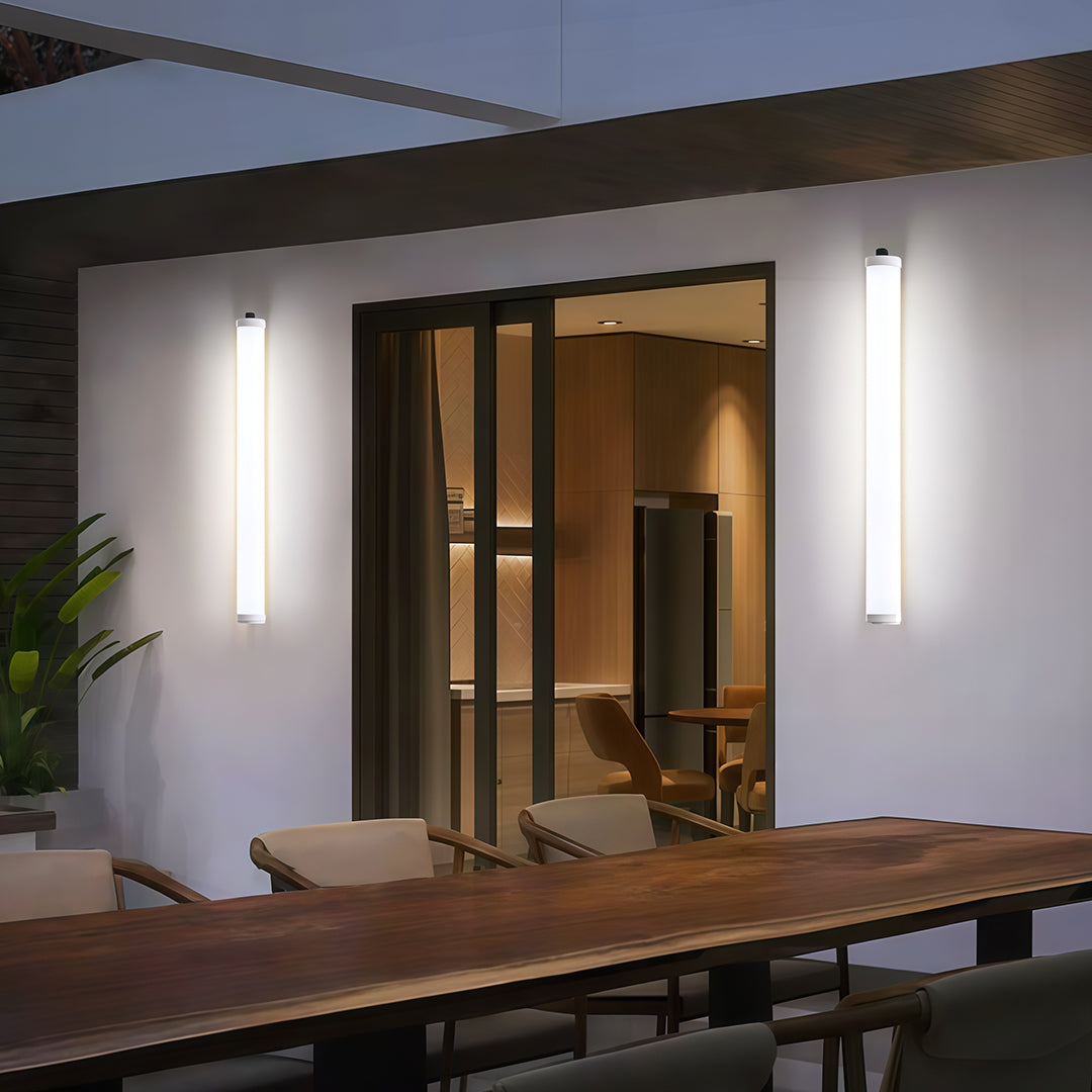 Sleek vertical outdoor wall lighting modern fixtures flanking a covered patio sliding door.
