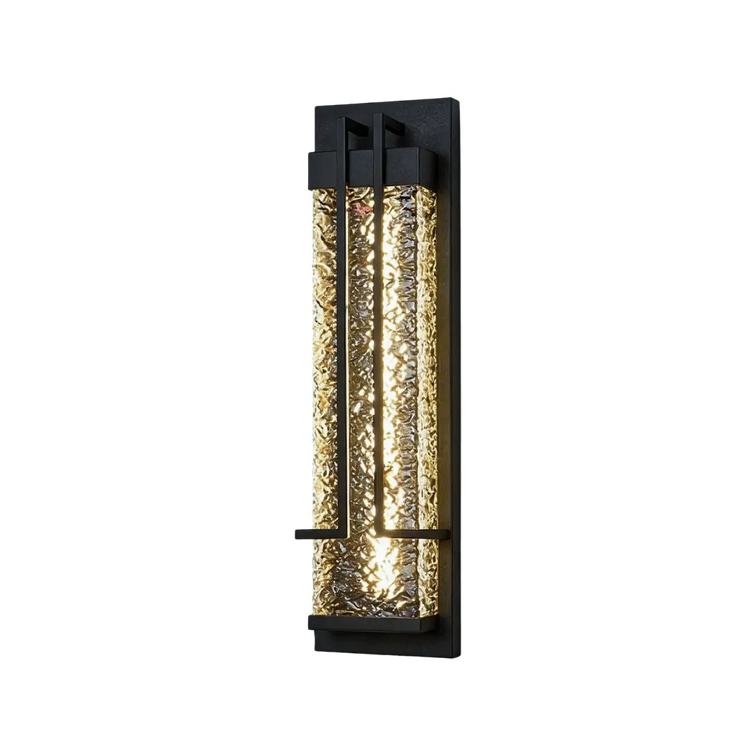 Vertical outdoor wall sconce with black metal frame and illuminated textured glass