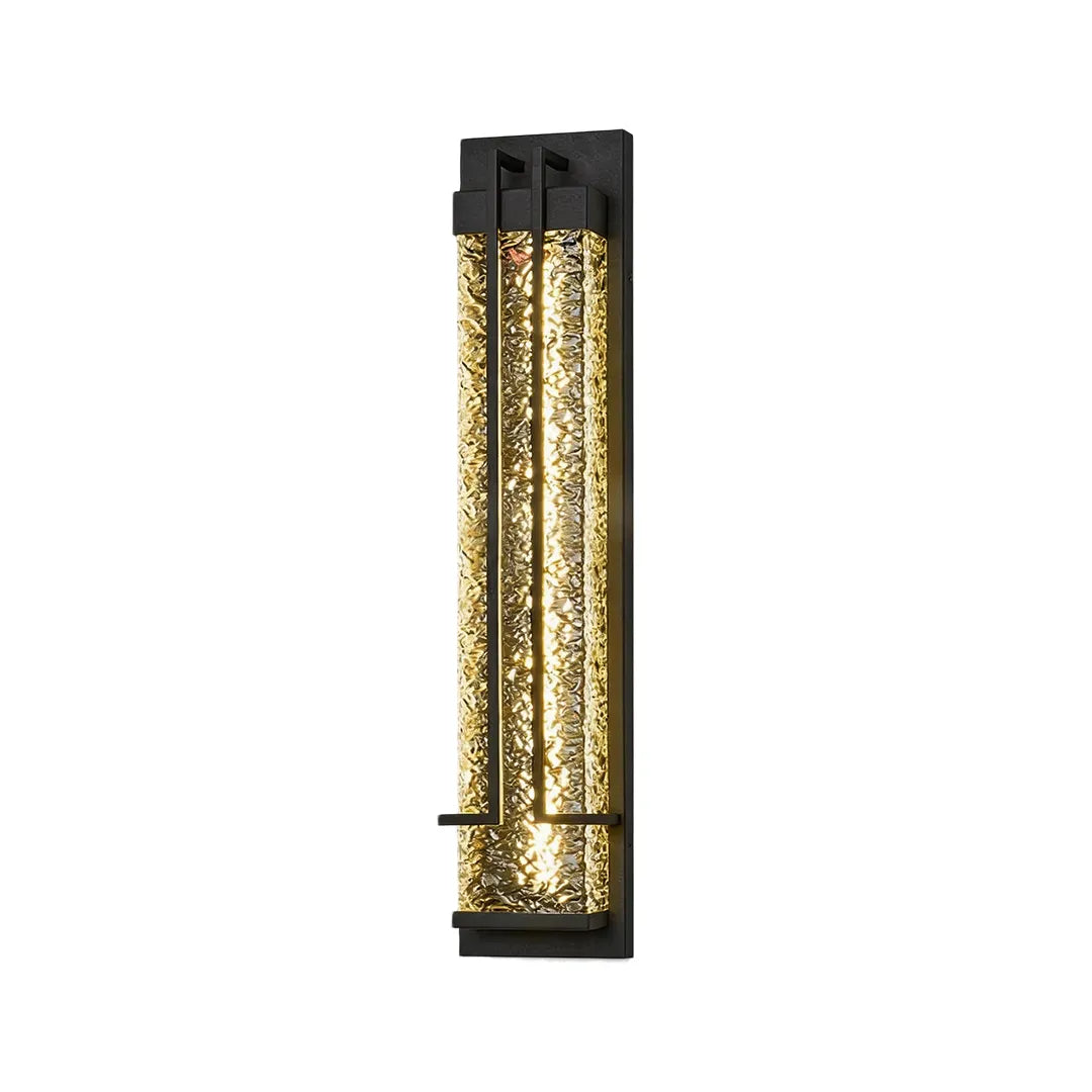 Vertical outdoor wall sconce with textured glass and warm ambient lighting
