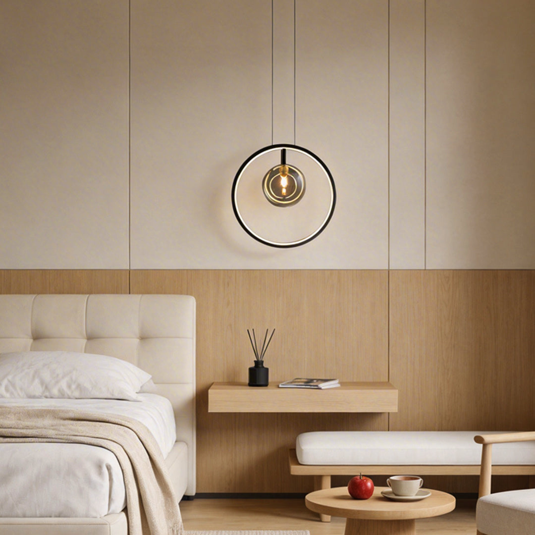 Vertical ring pendant light with a sleek circular design, illuminating a modern bedroom.