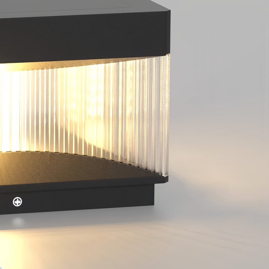 Vertical square pillar lights with elongated ribbed panel creating sophisticated outdoor lighting