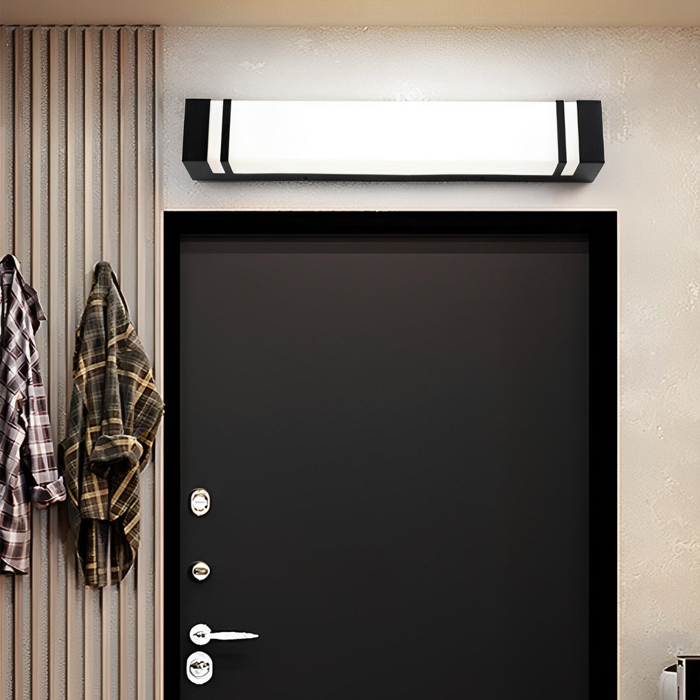 Vertical wall lighting above a black door, creating a striking contrast and contemporary appeal.