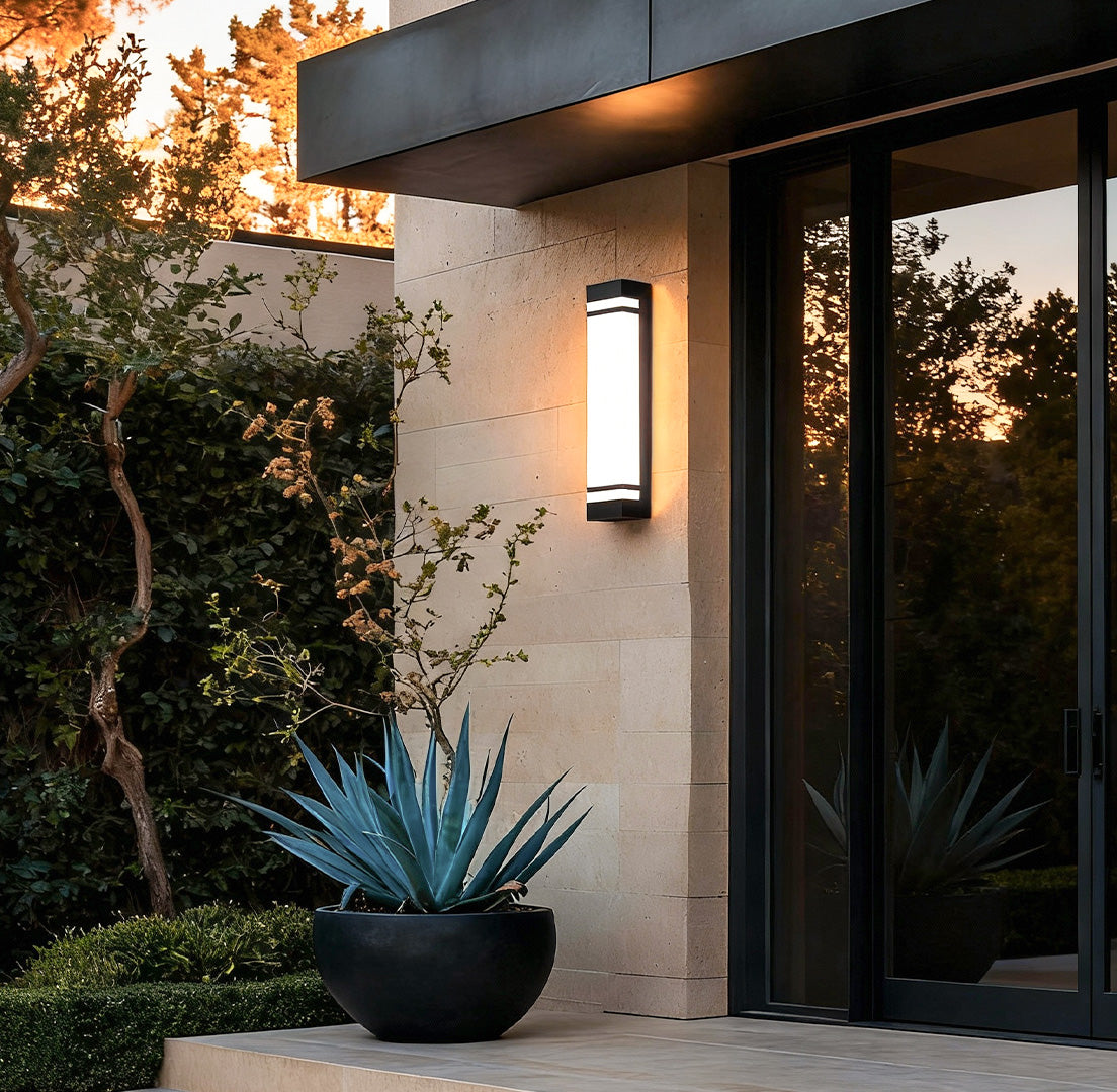 Vertical wall lighting installed at the entrance of a modern home, providing warm and welcoming illumination.
